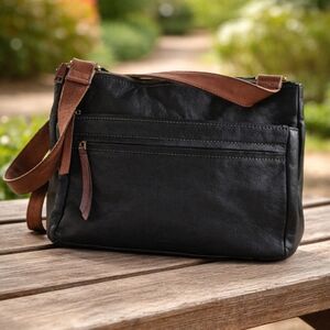 Fossil Corey black leather crossbody bag with a brown Leather strap. 